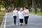 Happy asian family strolling embracing while relaxing and enjoying summer day in city park at leisure,smiling senior grandmother,