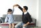 Happy asian father and daughter playing dance together in livingroom at home