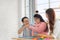 Happy asian father and mother playing education toy with their daughter down syndrome child in living room, Dad giving fist bump