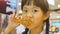 Happy Asian girl with fried chicken in restaurant