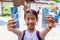 Happy Asian girl holds temple entrance tickets to visit buddha statue at Kotuku-in temple in Kamakura, Japan