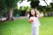 Happy Asian girl is playing a small orange ball. Child held a rubber ball in her hand and smiled sweetly.