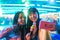 Happy asian girls eating candy sweets and taking selfie at amusement park - Young trendy friends having fun with technology trend