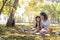 Happy Asian grandmother picnicking with her lovely granddaughter in park together. leisure and family concept