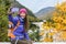 Happy asian hiker woman taking smartphone selfie at scenic viewpoint in nature fall mountain landscape outdoors. Girl hiking in
