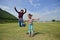 Happy Asian kids jumping with green grass