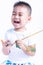 Happy asian little baby childhood playing use paintbrush draw watercolor or fingerpaint