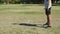 Happy Asian little girl kicking ball to her father outdoors