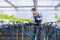 Happy Asian local farmer testing ph level of the water in the green oak salad lettuce greenhouse using hydroponics system in