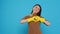 Happy asian maid wearing yellow gloves while doing heart shape in front of camera after finishing cleaning houses