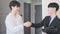 Happy asian male property owner shaking hands with real estate agent after signing contract. Home insurance and property