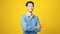 Happy asian man crossed arms while standing over isolated yellow background, Portrait of asia male smiling and looking at camera