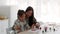 Happy Asian Mom And Little Daughter Drawing Together At Home