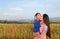 Happy Asian mother and daughters kissing in the meadow field at morning