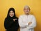 Happy Asian muslim couple proud of each other, pointing and smiling, lovefamily  good relationship