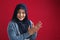Happy Asian muslim woman wearing hijab, happy proud clapping gesture, half body portrait