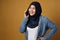 Happy Asian muslim woman wearing hijab talks on phone, female using smart phone, communication concept