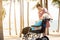 Happy asian old elderly in a wheelchair granddaughter relaxing enjoying on the sea beach together,teenager girl show love,take
