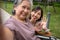 Happy Asian patients in a wheelchair use smartphones to take pictures with careful caregivers or nurse Concept of happy retirement