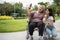 Happy Asian patients in a wheelchair use smartphones to take pictures with careful caregivers or nurse Concept of happy retirement