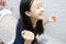 Happy asian people sitting on the toilet bowl,defecating or urinating in the bathroom,smiling child girl with relief and