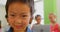 Happy Asian schoolboy standing in a classroom at school 4k