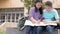 Happy Asian student girls study and discuss homework in school