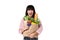 Happy Asian woman with credit card holding paper bag full of fresh vegetable groceries isolated on white background