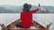 Happy asian woman relaxing in boat on the beautiful summer lake during her vacation. Pretty young girl sitting in boat