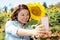 Happy asian woman selfy with sun flower in sunflower flower field.