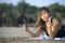 Happy Asian woman using mobile phone taking selfie portrait photo having fun relaxed