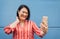 Happy Asian woman using mobile smartphone outdoor - Senior having fun with new trendy technology for social media apps