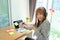 Happy Asian woman wearing mask pump hand gel alcohol cleaning sanitizer working from home