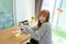 Happy Asian woman wearing mask pump hand gel alcohol cleaning sanitizer working from home