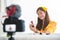Happy Asian young beauty blogger girl training how to be make up artist in home studio. Woman speaking in front of camera as