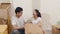 Happy Asian young couple bought new house. Korean family opening unpacking cardboard boxes and easy and fast service commerce