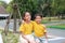 Happy Asian young girl child and little boy kid hug the neck and smile. Portrait Caucasian little brother and older sister hugging