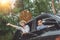 Happy asian young travellers with drive car off road in forest