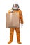 Happy astronaut wearing orange space suit and space helmet holding in hand blank kraft paper bag isolated on white