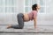 Happy Attractive Asian Pregnant woman practice Cat Cow Pose to meditation smile with big belly in the morning comfortable and