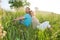 Happy attractive couple sitting together at outdoors picnic. Couple on grass in summer forest in green grass.