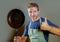 Happy attractive home cook man with cooking pan smiling satisfied and proud giving thumb up domestic chef and house husband lifest