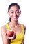 Happy attractive indian girl giving an apple