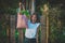 Happy attractive vegan woman holding reusable grocery bag full of vegetables