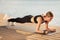 Happy Attrative Middle Aged Female In Activewear Planking On Wooden Pier Outdoors
