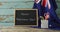 Happy australia day text and australian flag with stars and school items on wooden table