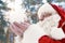 Happy Authentic Santa Claus blowing snow from his hands
