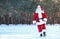 Happy Authentic Santa Claus walking outdoors.