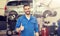 Happy auto mechanic man or smith at car workshop