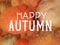 Happy Autumn in white typography letters on slightly blurred and textured orange pumpkins and gourds, fall festival or autumn harv